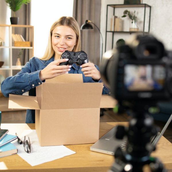 woman-recording-video-while-unpacking-box-with-joystick.jpg